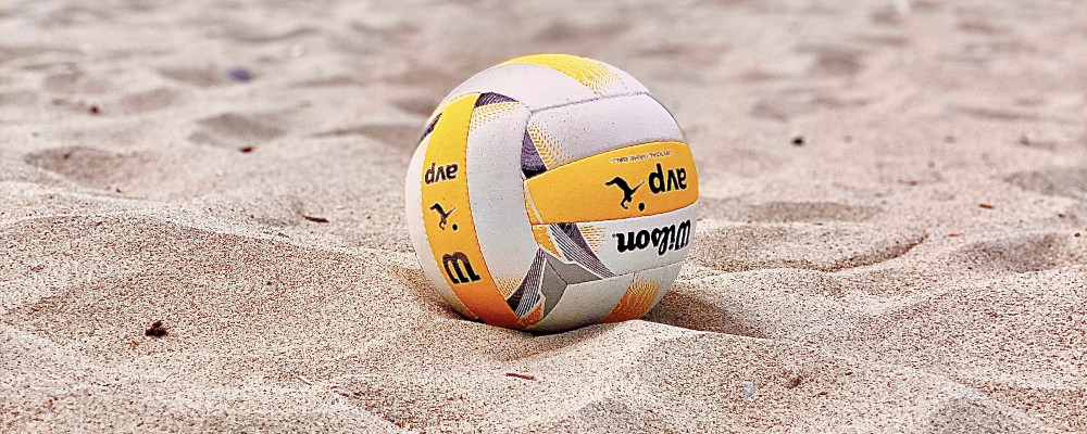 a beach volleyball ball in the sand