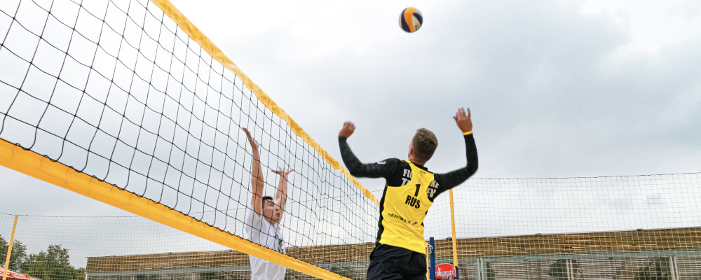 two guys playing beach volleyball