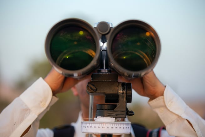 Man looking through binoculars